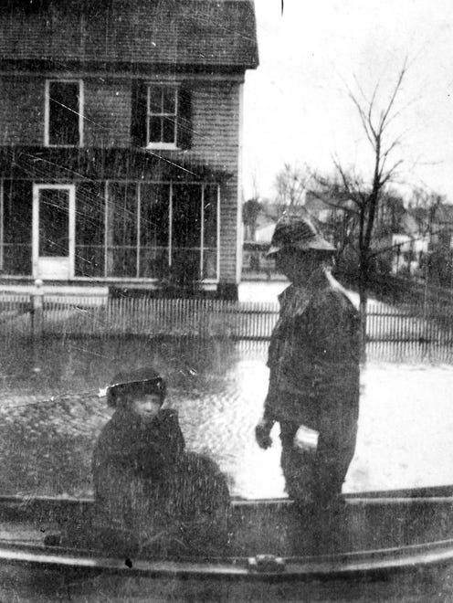 This photo shows a young lady being evacuated by boat from her home in Greenbackville. Despite its poor quality, the photo has historic value as it is one of the few known photographs showing people dealing with the extensive flooding.