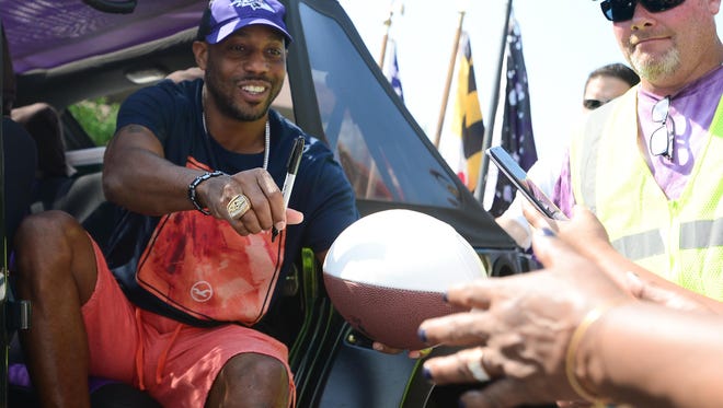 Former Raven's defensive Back Duane Starks signs autographs during the Raven's Roost parade in Ocean City on Saturday, June 3, 2017.