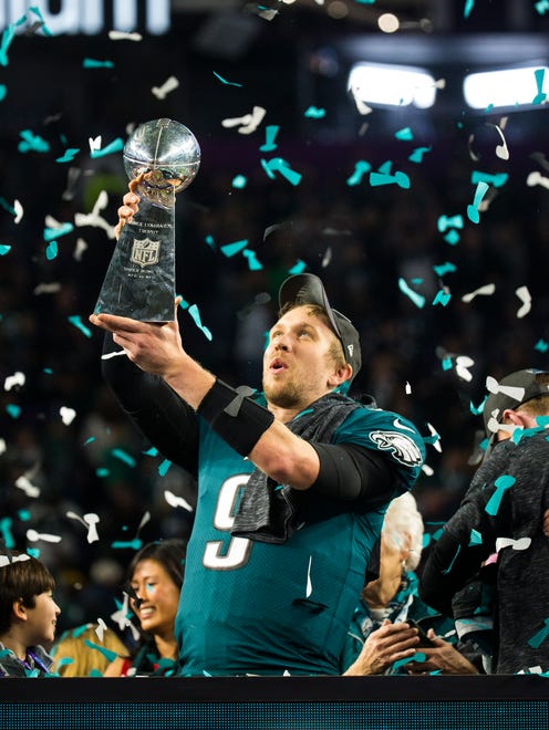 Eagles quarterback Nick Foles holds up the Vince Lombardi Trophy after defeating the New England Patriots 41-33 to win Super Bowl LII Sunday night.