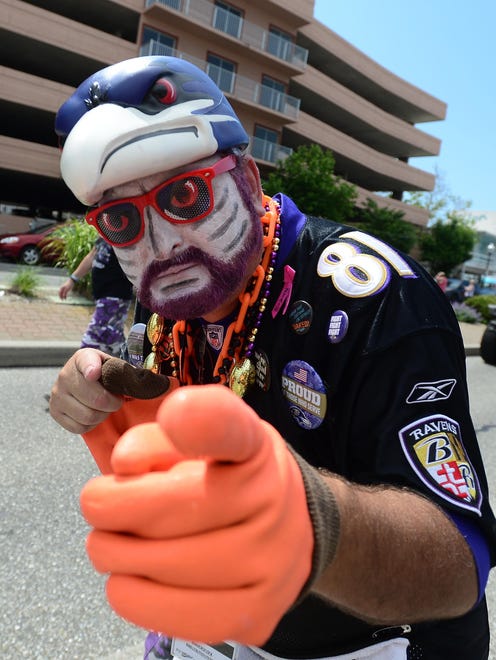 A decked out Ravens fan walks in the Ravens Roost parade held in Ocean City on Saturday, June 3, 2017.