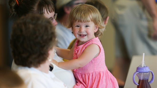 Madison Hallett, 2, laughs during a press conference at the Blue-Gold media day.