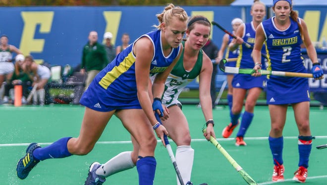 Delaware forward Greta Nauck (21) advances the ball downfield as Ella Donahue (13) defends in the second half of the CAA field hockey finals in 2017.
