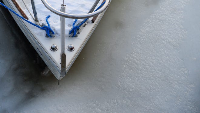 An icy sail boat sits in a frozen Lewes Canal on Friday, Jan. 5, 2018.