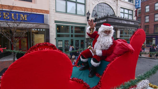 Santa waves to crowd during the Wilmington Jaycees 53rd annual Christmas parade in Wilmington.