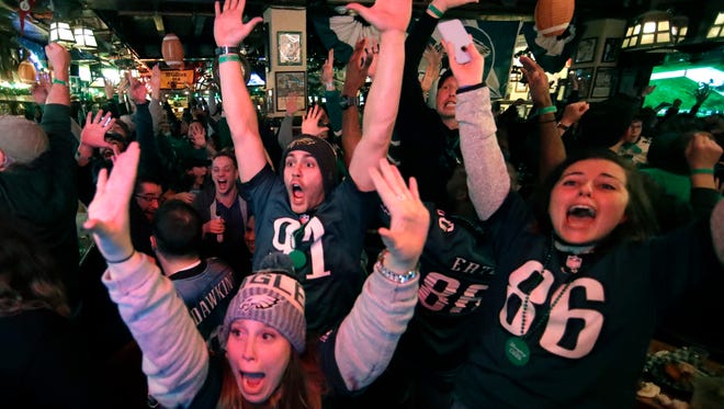 Fans react to an Eagles touchdown during Super Bowl 52 between the Philadelphia Eagles and the New England Patriots, Sunday, Feb. 4, 2018, in Philadelphia.