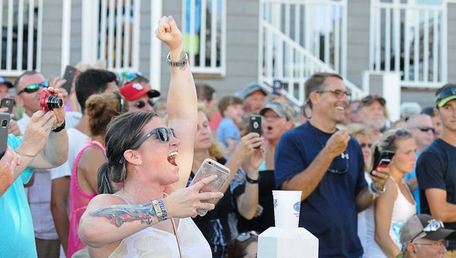 Jillian Shields cheers as her fathers boat the Sea Flame has just weighed in a 39 pound tuna to become the new leader. During the 43rd Annual White Marlin Open on the last day of the tournament. Megan Raymond Photo