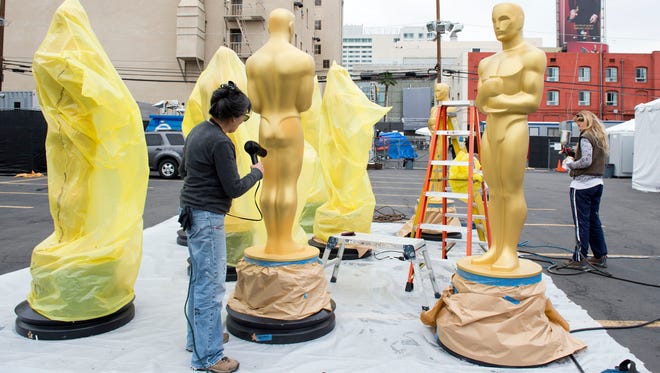 Artists paint Oscar statues for the 89th annual Academy Awards earlier this week in Hollywood, California.