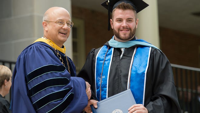 President Mr. Robert E. Clark II poses for a photo with John William Wolgamot at the Wesley College Spring Commencement in Dover.  A total of 244 graduated.