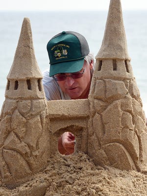 Andy West from Harrington makes a castle as The 38th Annual Rehoboth Beach-Dewey Beach Chamber of Commerce Sandcastle Contest was held on Saturday, Sept. 10, 2016 at a new location on the south end of the beach near Funland under hot weather conditions.  Participants worked to create different castles and sculptures in the sand for judging in the late afternoon at which time trophy's ail be given out.