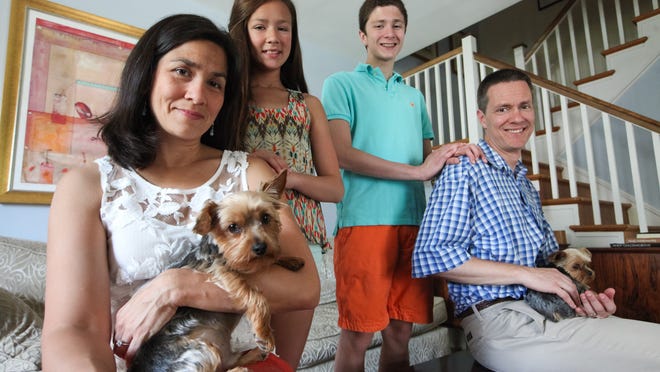 Husband-and-wife authors Marisa de los Santos and David Teague with their children Annabel, 12, and Charles, 15, and dogs Finny (left) and Huxley at their home in North Wilmington.