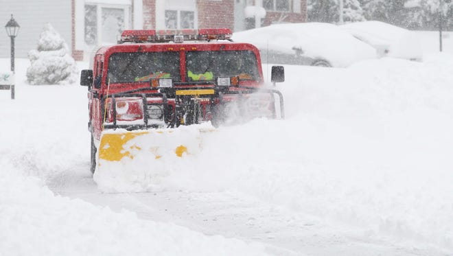 A Hockessin Fire Company Hummer clears snow off Pershing Road in Hockessin.