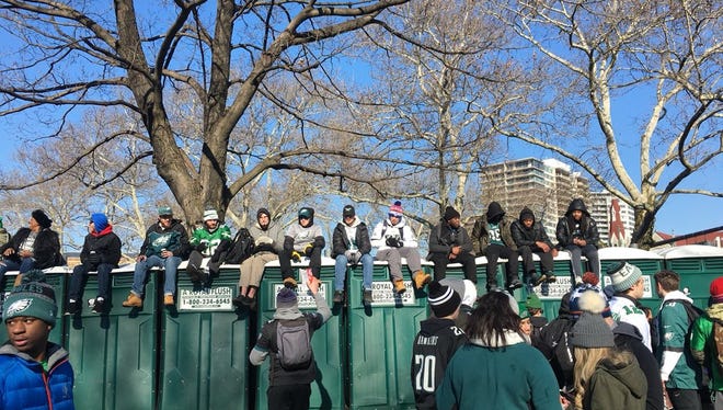 Eagles fans try to get a better vantage point for a celebratory parade in Philadelphia Thursday.