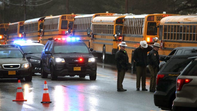 School buses are lined up in front of Great Mills High School after a shooting on March 20, 2018 in Great Mills, Md.
