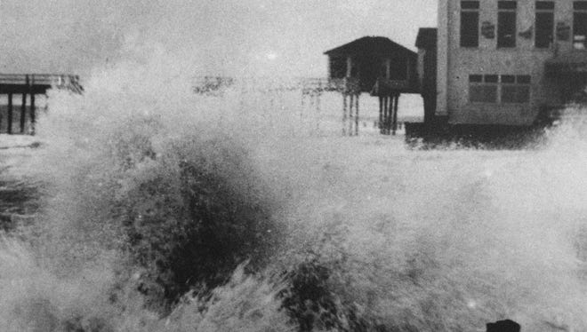 Heavy seas smash against the Boardwalk near the pier building during the storm of 1933.