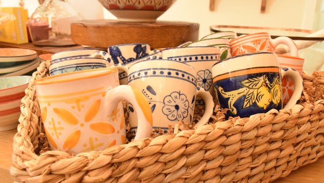 Hand-painted mugs add a touch of brightness to the space.