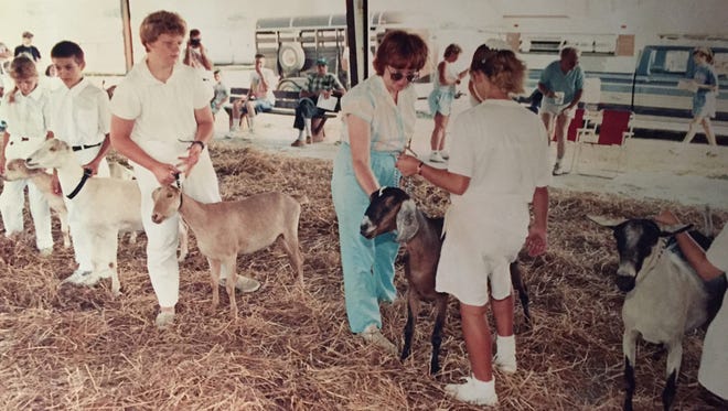 1990: Judge Martha Griner looks over goats owned by children 13 and younger. See more vintage images of the Delaware State Fair.