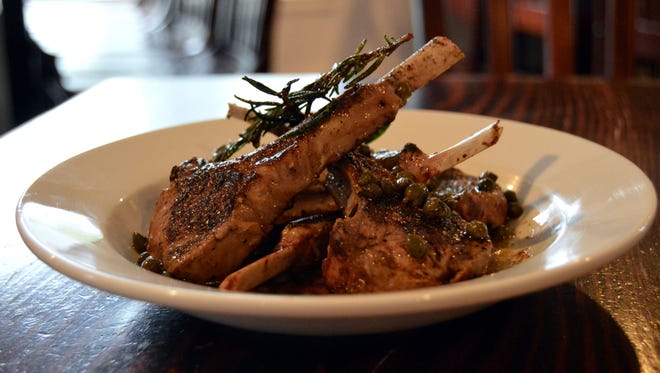 The grilled lamb chops, topped with rosemary, capers and burnt butter sauce by the Dewey Beach Club.