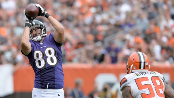 Baltimore Ravens tight end Dennis Pitta (88) catches a pass over the defense of Cleveland Browns inside linebacker Chris Kirksey (58) during the second half at FirstEnergy Stadium.