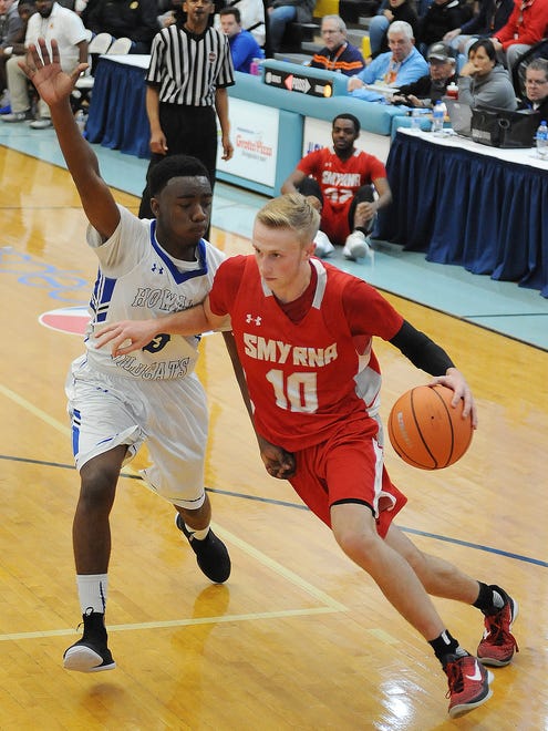 Smyrna's #10 Caleb Matthews drives for the basket as Smyrna High School (red) defeated Howard High School (white) 86-53 in the opening game of the Slam Dunk to the Beach Tournament held at Cape Henlopen High School on Wednesday December 27th. 
Special to the News Journal / CHUCK SNYDER