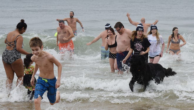 About thirty people braved the cold and made the plunge into the ocean at Dagsworthy Street in Dewey Beach on Sunday as the postponed "Dewey Dunk" was finally held after being postponed due to frigid conditions in January.