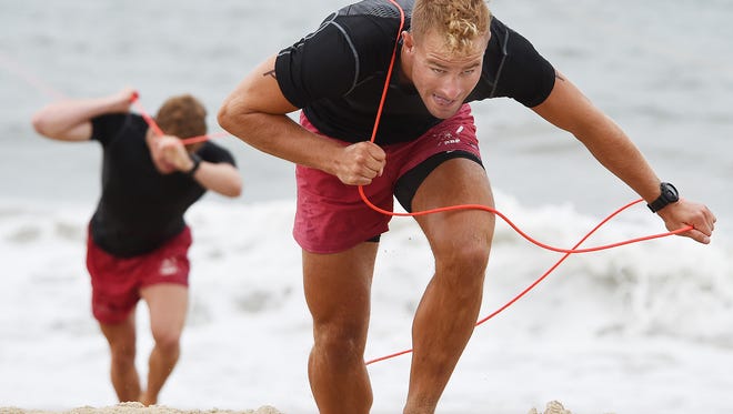Rehoboth Beach Patrol members Cody Quig and A.J. Brady pull the rope in the landline competition.