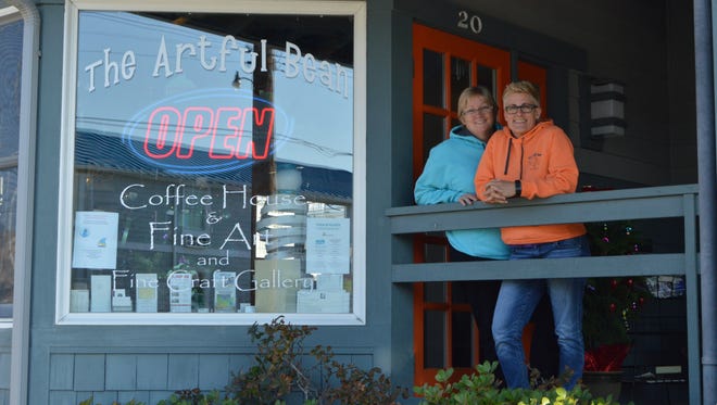 Rose O'Hanlan and Kim Warner smile in front of their coffee shop, the Artful Bean in Bethany Beach