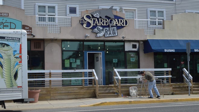A construction worker builds the railing for the Starboard Raw Bar, March 24.