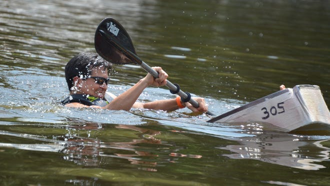 Alex Stroup, of Seaford, has that sinking feeling in his cardboard boat but he hung on to finish the race. The Cardboard Boat Regatta, part of the Reclaim Our River Nanticoke Series, is designed to raise awareness and money to help improve the river.