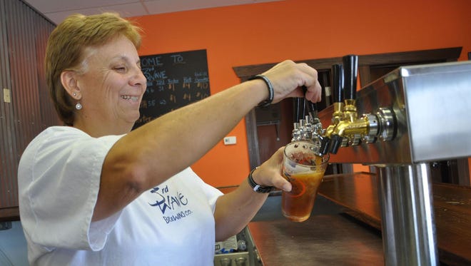 Co-owner and brewery manager Lori Clough pours a beer at 3rd Wave Brewing Co. in Delmar.