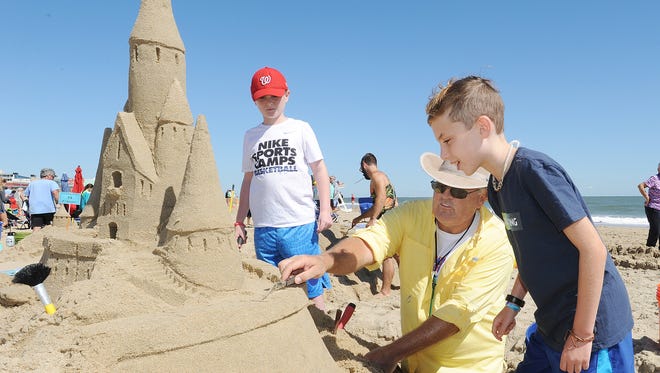 Darryl O'Conner from Dewey Beach show Drew and James Eichberg from Bethesda, MD haw to scalp sand as Great weather had many beach artists attend the Rehoboth Beach-Dewey Beach Chamber of Commerce's Annual Sandcastle Contest held on the beach at Brooklyn Avenue in Rehoboth Beach on Saturday September 9th.
Special to the Daily Times / CHUCK SNYDER