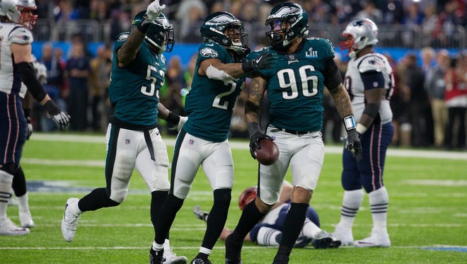 Derek Barnett, right, celebrates with his teammates after picking a fumble made by Tom Brady late in the 4th quarter Sunday at US Bank Stadium.