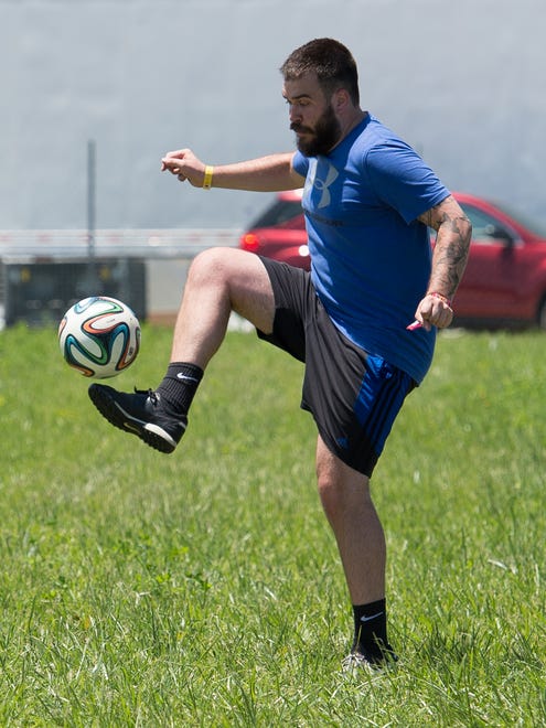 Zach Roberts of Grand Rapids, Mich., plays soccer on a field that the Firefly Music Festival set up in the north camping area, a request that festival goers ask for this year.
