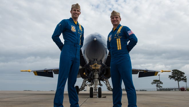 Blue Angels pilots, Lt. Brandon Hempler, left, and Lt. David Steppe pose for a photo in front of their Boeing F/A-18 Hornet at Wallops Flight Facility on Tuesday, Nov. 29, 2016.