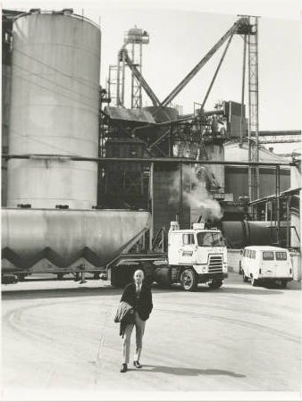 Photograph taken about 1965 of Frank Perdue of Perdue Farms, Inc., standing in front of his grain storage tanks near Salisbury, Maryland. A truly "self-made man", Frank Perdue has contributed much to the prosperity of the Delmarva Peninsula.