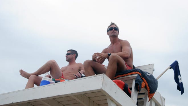 Bethany Beach Patrol lieutenants Matt Farlow, left, and Christian Sears keep an eye on the beach after Aug. 7-9 saw 72 rescues due to rough surf.