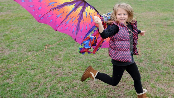 7 year Scarlett Clarkson from Buffalo, NY runs with her kite as despite cloudy and rainy weather, the 48th Annual Kite Festival was held on Friday March 25th at Cape Henlopen State Park near Lewes with a good crowd on hand flying all kinds of kites and creations.