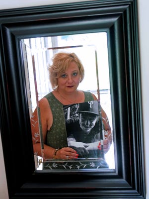 Penny Rogers holds a picture of her 23-year-old son, Vincente Tambourelli, who died of a heroin overdose less than a month ago.