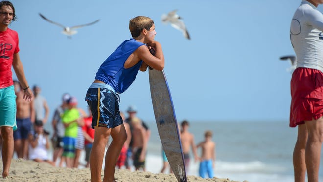 Jack Lee, Rehoboth, waits for the perfect wave during his heat in the semifinals of the Skim USA Association ZAP Pro/Am Skimboarding Competition in Dewey Beach, De. on Friday, August 11, 2017.