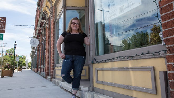 Daily Brew Coffeehouse owner, Lori McAllister, poses for a photo outside her Washington Street store on Tuesday, June 14, 2016.