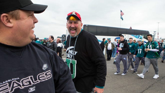 Davids Schofield of Telford, PA rolls around the parking lot "walking the dog" as Eagles fans begin their tailgating early Sunday morning in the NFC Championship game at Lincoln Financial Field.