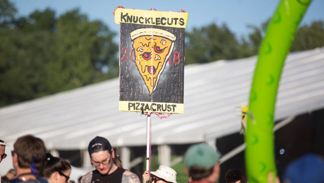 Signs, banners, and flags used by festival goers to keep their groups together at Firefly Music Festival in Dover.