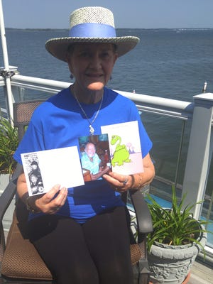 Judy Schoellkopf holds cards and photos in remembrance of her late husband Herbert Schoellkopf, who founded Old Pro Golf in Ocean City.