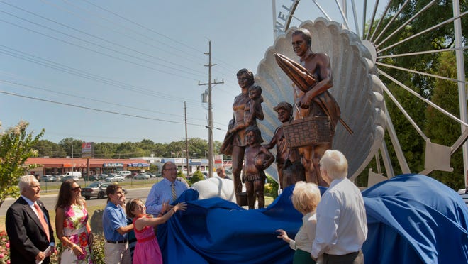 Cover is pulled back during unveiling of Welcome To Ocean County Monument on August 14, 2014 in Toms River. Monument represents all the residents of Ocean County and was created by sculptor Brian P. Hanlon and donated by the Jay & Linda Grunin Foundation.  - Peter Ackerman / Staff Photographer