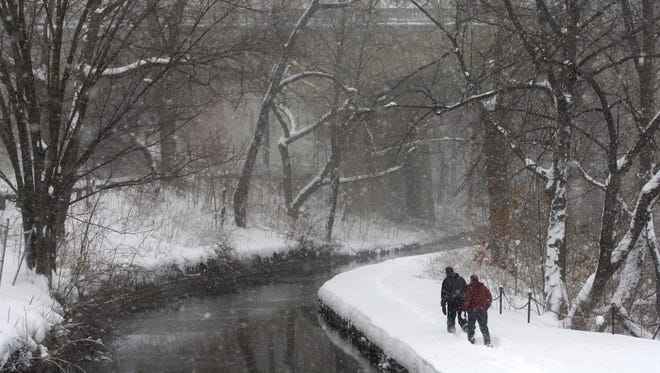 Jenny Krumrie and her boyfriend, John Lehmann, both of Wilmington, snowshoe along the raceway in Brandywine Park as snow continues to fall in Wilmington, Saturday afternoon, Feb. 6, 2010.