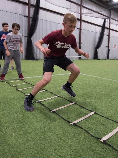 Carter Boyd (12) of Middletown works the ladder drill during a training session with Sports Specific Training at Slim's Sport Complex in Middletown.
