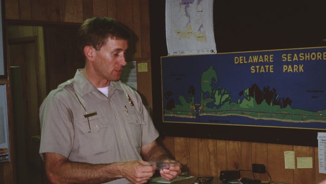 Park Superintendent Doug Long issues a park pass in this 1998 park photo.