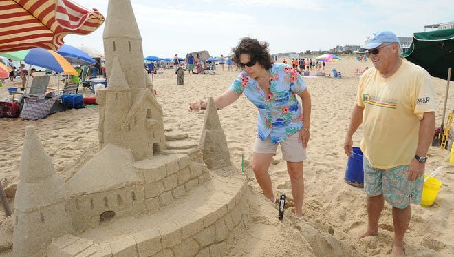Long time Sandcastle builder Darrell O'Conner, from Dewey Beach, was on hand to show Barbara Dempsey from Drexel Hill, PA how to work the sand.