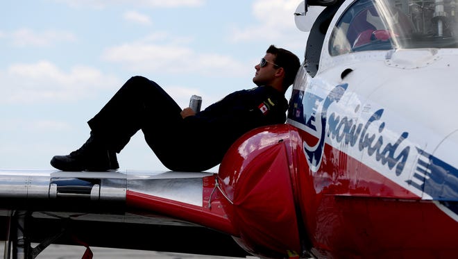 Structural technician Marc De-Serres of Dartmouth, Nova Scotia,rests on the wing after landing at Willow Run Airport in Ypsilanti.