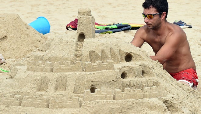 John Dundore from Lebanon, PA. works at his castle as The 38th Annual Rehoboth Beach-Dewey Beach Chamber of Commerce Sandcastle Contest was held on Saturday, Sept. 10, 2016 at a new location on the south end of the beach near Funland under hot weather conditions.  Participants worked to create different castles and sculptures in the sand for judging in the late afternoon at which time trophy's ail be given out.