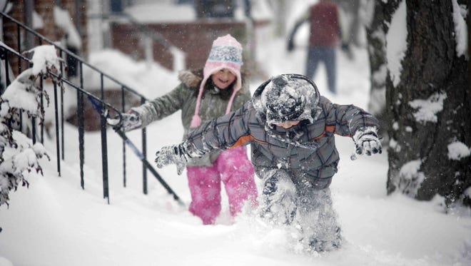 Dominic Rispoli, 6, of New Castle, right, and Jenna Wrightson, 7, of New Castle, play in the snow on 6th Street in Old New Castle Saturday, February 6, 2010.